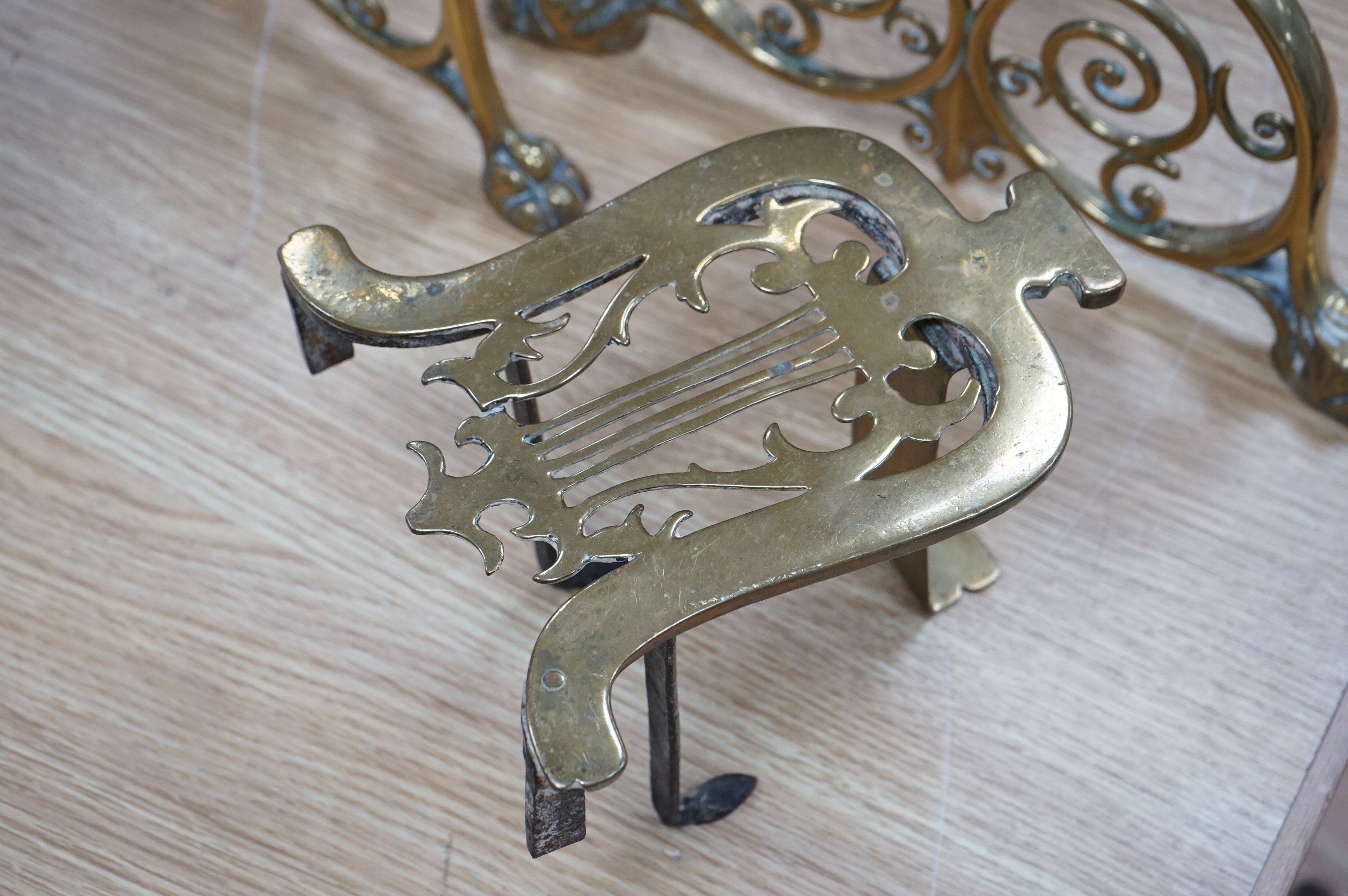 A pair of Victorian ornate brass fire dogs and two trivets, fire dogs 48cm high. Condition - good